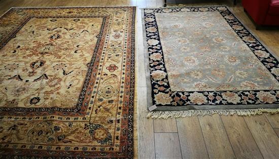 A Persian cream and pink ground carpet and a smaller carpet, with dark blue border (2) 245 x 158cm, 305 x 238cm